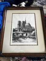 Full view of framed artwork of Notre-Dame de Paris showing the entire illustration and frame.