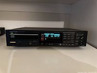 Front view of Onkyo Integra DX-200 CD player showing power on with digital display.
