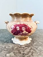 Front view showing scalloped rim, transfer portrait of Queen Victoria and Prince Albert