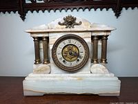 Front view of alabaster mantel clock showing case, columns and dial