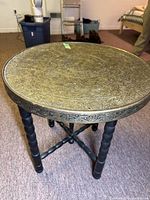 Full view of table showing removable brass top and folding legs