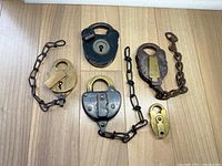 Overview of five padlocks on wooden surface