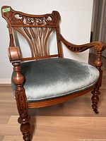 Front and side view of Irish Wheat Back armchair showing carved crest rail, curved arms and upholstered seat