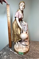 Full view of the Royal Dux porcelain figurine next to a ruler showing height approximately 15 inches.