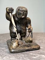 Front view of hunter figure on rectangular base with harpoon attached by wire