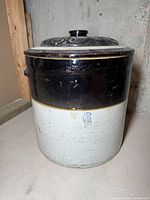 Full view of a six gallon stoneware crock with a lid, showing the two-tone dark brown and beige glaze.