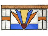 Colored stained glass panel with ruler showing overall dimensions and design