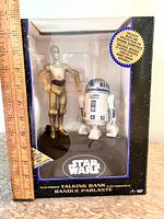 Boxed Star Wars electronic talking bank with R2-D2 and C-3PO figurines visible inside.