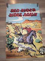 Full view of the vintage Red Ryder poster with cowboy on horse and desert background
