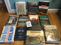 Photo showing all 11 Civil War books arranged on the floor, titles clearly visible including 'April 1865', 'Battle Cry of Freedom', and others.