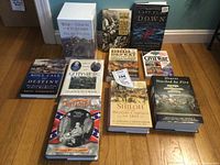 Full view of the 13 Civil War themed books arranged on a hardwood floor showing titles and condition.