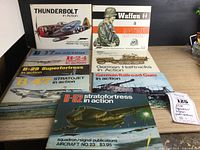 Full lot of nine Squadron/Signal Publications books showing covers of military aircraft and weaponry from WWII and Cold War eras.