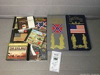 Photo showing a collection of nine CDs arranged on a surface including two boxed sets titled 'The Confederacy 1861-1865' and 'The Union 1861-1865' with patriotic flags and soldier silhouettes as well as several individual jewel case CDs with Civil War and patriotic cover art.