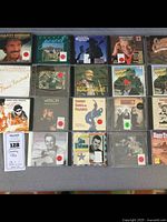 Photo showing multiple country and rockabilly music CDs laid out with visible cover art including artists like Marty Robbins, Johnny Paycheck, Boxcar Willie, and others.