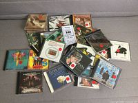 Overview of all 13 CDs loosely stacked with sale tag visible