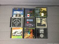 Photo of 9 CDs featuring Leo Kottke albums with varied cover art and colors.