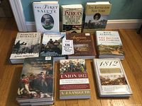 Overview photo of all 10 books arranged on a wooden floor showing their full front covers, titles, and cover images related to American historical wars.