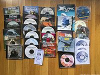 Photo showing several simulation game DVDs in cases and loose discs, titles include Pro Train I and II, Sandpatch, X Plane 10, and Wings Over Europe among others.