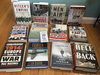 Photo showing all 12 WWII books arranged on floor, titles visible and dust jackets present.