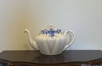 Front view of entire teapot on display surface
