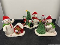 Set of three Hallmark Jingle Pals plush snowmen with accessories showing full lot