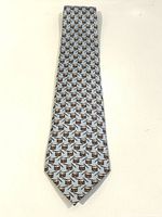 Full length view of pale blue silk tie with repeating drum pattern