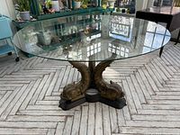 Full view of round glass tabletop and brass koi fish base