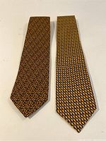 Two Salvatore Ferragamo ties laid flat side by side, showing overall pattern and color.