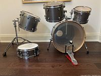 Front view of bass drum with pedal and two rack toms mounted