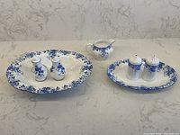 Full set of Shelley Dainty Blue serving pieces and Royal Albert tray displayed on countertop.