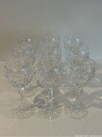 Nine glasses arranged in three rows.