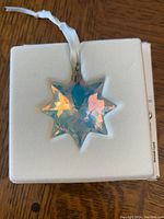 Front view of the star-shaped crystal ornament showing iridescent colors.