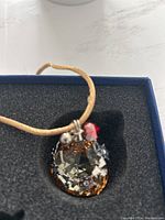 Bell-shaped Swarovski Christmas ornament with golden shadow crystal, red heart, snowflakes, hanging on gold string inside original box
