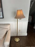 Full view of the swivel brass floor lamp with fabric shade, showing height, base, and current lampshade.