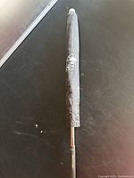 Golf umbrella closed with black protective cover showing logo