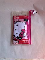 Packaged two-pack Hello Kitty cleaning cloths in clear pink plastic pouch with Hello Kitty graphics.