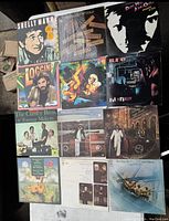 View of eleven vintage vinyl records with original album covers showing various music artists and artwork.