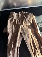 Photo of rear side of women's tan brown pants showing back and waistband.