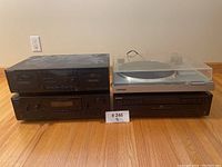 All four Sony stereo components stacked: cassette deck, receiver/amplifier, CD player, and turntable on top with dust cover closed.