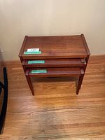 All three teak nesting tables nested together