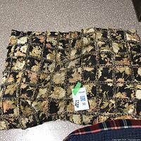 Quilted dog blanket with patchwork floral pattern, tag visible