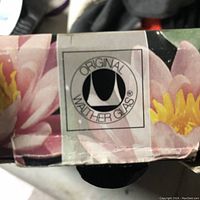 Close-up of original Walther Glass logo on the box with floral background print.