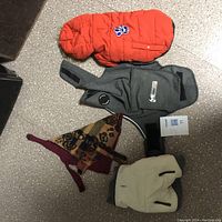 Overview of all four small dog coats displaying different styles and colors