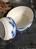 Photo showing both bowls, one with blue and white exterior and one plain white.