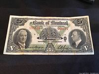 Full front view of note showing portraits, crest and serial number