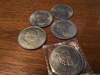 Five Canadian coins from 1965 including Churchill and Queen Elizabeth II. One coin in plastic cover.