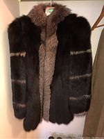 Full front view of the dark mink coat hanging in closet