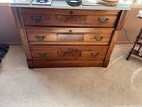Front view of dresser showing three drawers and marble top