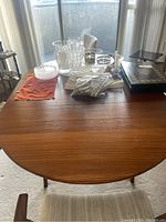 Full tabletop view with accessories showing round top and wood grain