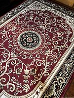 Full view of vintage large rug with red floral design and central medallion